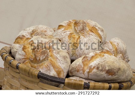 Several traditional breads in a basket in the bakery. Typical bread of Galicia, Spain. Stock photography.