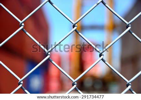 Wire mesh fence enclosing the container yard Royalty-Free Stock Photo #291734477