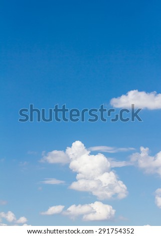 blue sky with cloud closeup and bright sun, vertical cloud in sky,