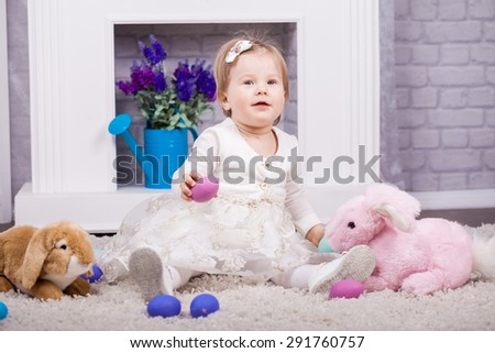 Small child playing with Easter holiday eggs
