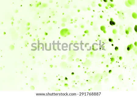 Abstract Bokeh background created by light and water spray in green color.