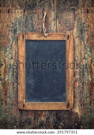 Antique chalkboard on wooden texture. Rustic background with copy space for your text. Vintage style toned picture
