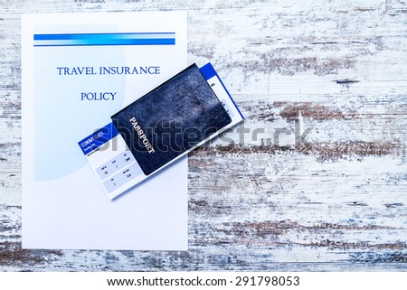 
Travel insurance policy booklet with a boarding pass and a passport
