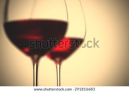 red wine in two goblets. romantic blur still life. instagram image filter retro style