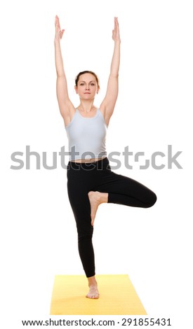 young woman practising yoga exercises on yellow mat isolated on white background