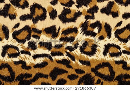 Brown leopard fur pattern. Spotted animal print as background.