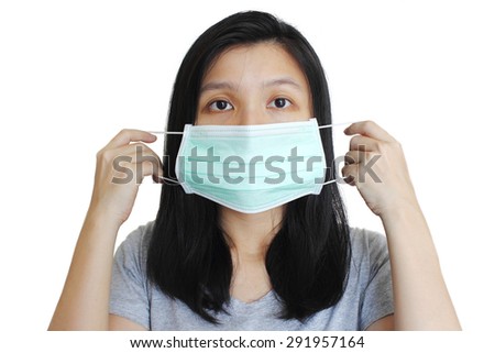 Portrait of Asian woman putting on medical mask on white background. 