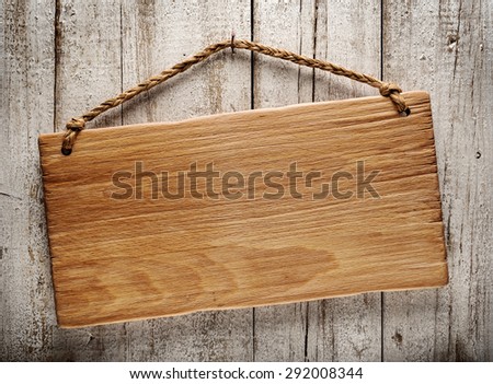rustic wooden signboard hanging on grunge wall
