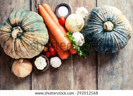 Farm market photo with different vegetables and greens - view from the top. Organic products and healthy lifestyle photography. Fresh food on the wooden background. 