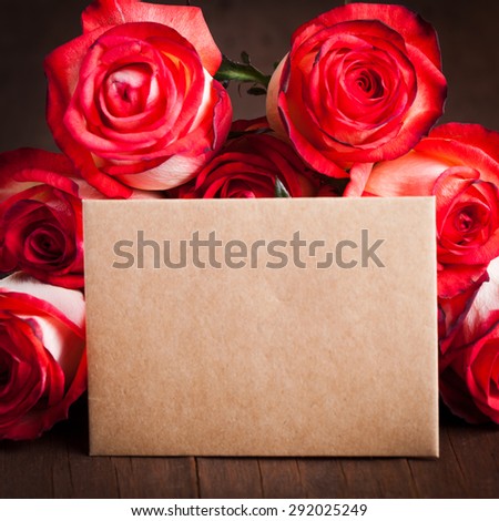 Roses and blank craft card on the table