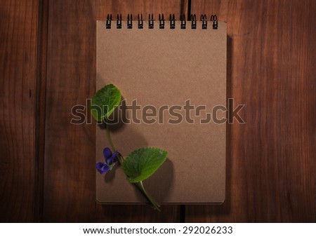 Old notepad on the wood background
