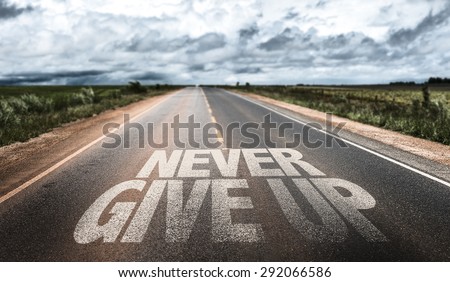 Never Give Up written on rural road Royalty-Free Stock Photo #292066586