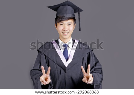 Full isolated studio picture from a young asian graduation man
