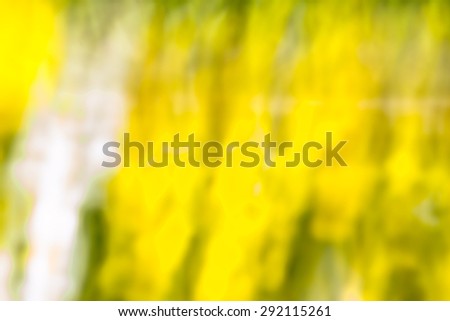 Photo of blurry abstract background of colorful summer garden photographed on long exposure with motion effect.
