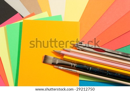 school supplies on set of colored papers