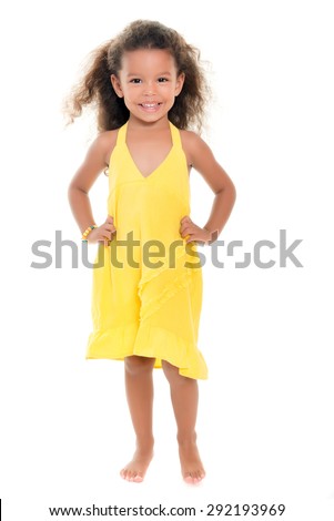 Cute small african-american or hispanic girl wearing a yellow summer dress isolated on white