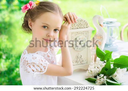 Little smiling girl with big clock. People, time management and children concept. Vintage style. Facial Expression.
