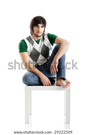 Young man portrait seated over a white background