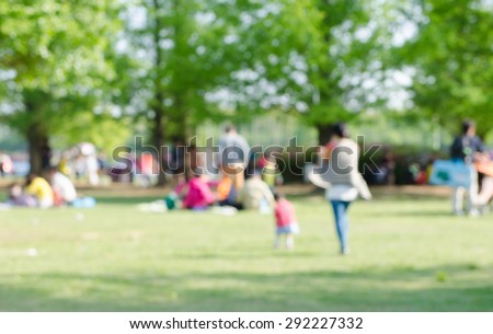 Blurred background of people in park, spring and summer season