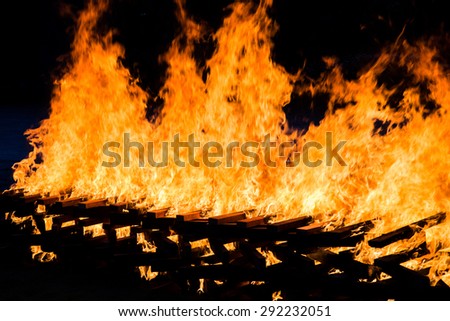 Fire burning wood pile , closeup abstract background