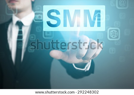 Businessman pressing button on touch screen interface and select smm business concept.
