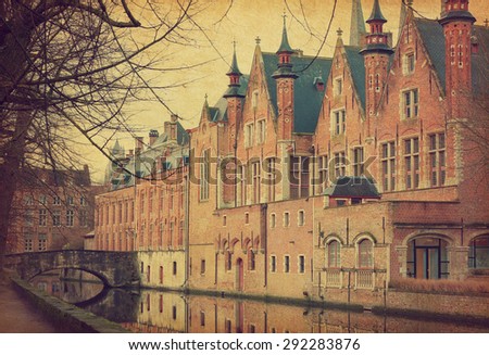 A canal in Bruges, Belgium. Photo in retro style.  Added paper texture. 