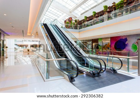 Escalator in modern shopping mall Royalty-Free Stock Photo #292306382