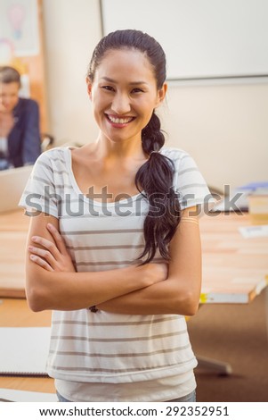 Standing young businesswoman smiling at the camera