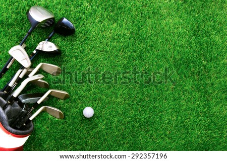 Golf ball and golf club in bag on green grass Royalty-Free Stock Photo #292357196