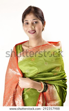 Fashion portrait of beautiful female wearing traditional indian costume, over white background