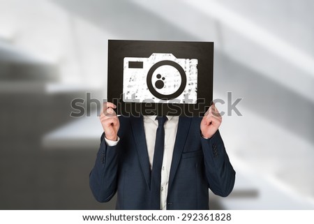 Businessman holding board against white staircase in a home