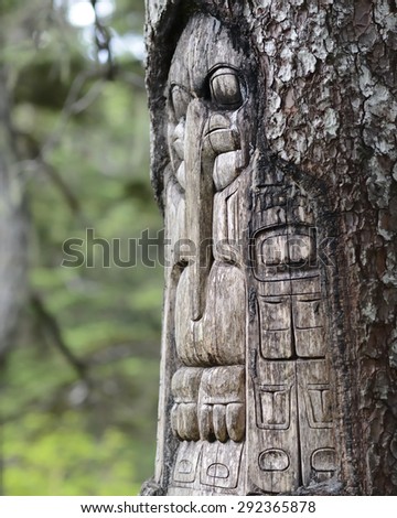 Wood Totem Pole carved by native Tlingit indians along a trail on top of Mt. Roberts in Juneau, Alaska, USA. 