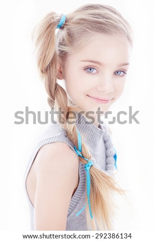 Cute little girl with long hair and blue eyes.