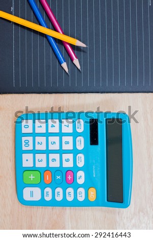 Glasses and pen on a notebook,Calculator