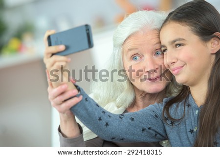 Little girl taking a selfie with her grandma