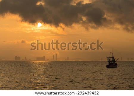 Sunrise over the sea and the city