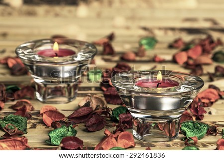 Red candles in sconces, closeup on a colorful background
