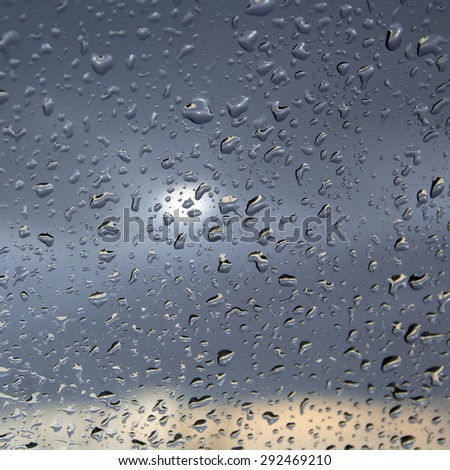 macro texture of raindrops on glass of the car spring