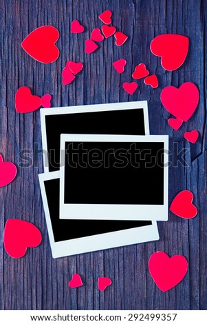 Blank instant photo and small red paper hearts