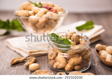 ripe peanut with more fresh mint in a glass container