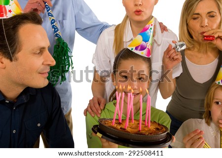 family celebrating birthday party with cake