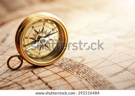 Old compass on vintage map. Retro stale. Shot with shallow depth of field.