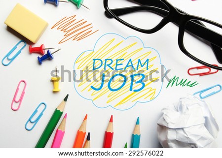 Dream job concept with some office supplies around it on white background.