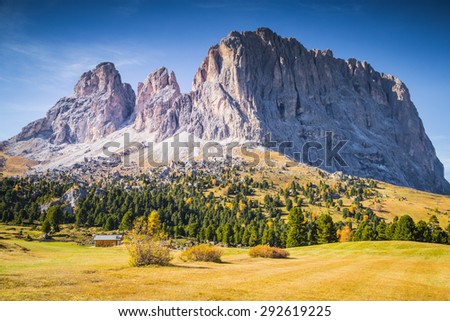 Sassolungo, Val Gardena, Italy. The Sassolungo alp standing over colorful fields during the autumn season in Val Gardena, Trentino Alto Adige, Italy.