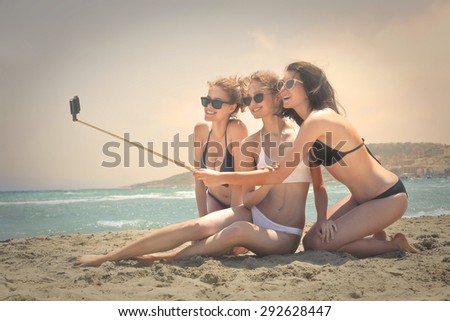 Three girls doing a selfie at the seaside