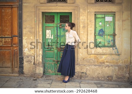 Beautiful woman wearing a long blue skirt Royalty-Free Stock Photo #292628468