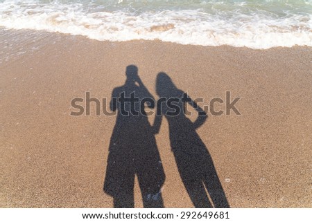 Shadow Of Boyfriend And Girlfriend Lovers Taking Photos On Beach