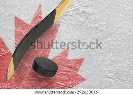 Hockey puck, stick and a fragment of an image of the Canadian flag