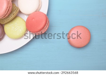 Sweet and colourful french macaroons on retro-vintage background