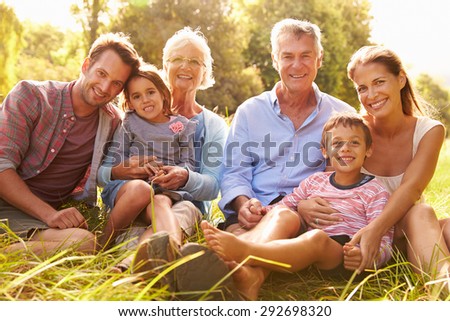 Multi-generation family relaxing together outdoors Royalty-Free Stock Photo #292698320